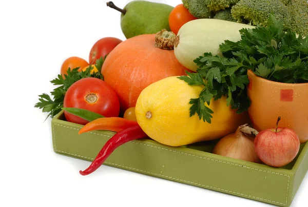 Légumes frais dans une boîte verte sur fond blanc . — Photo