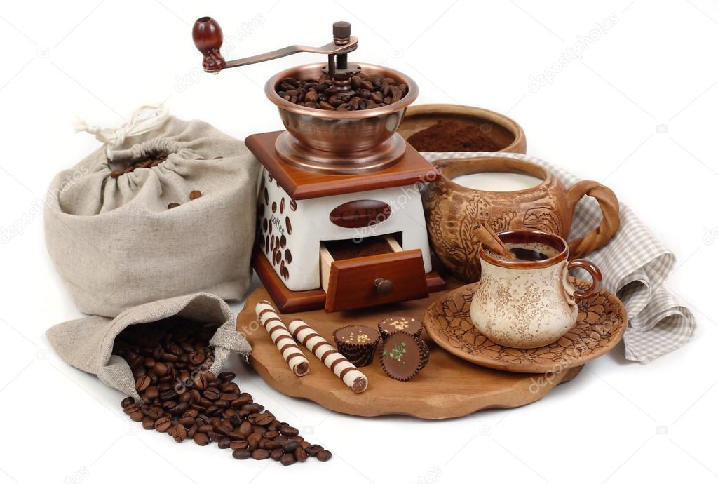 Cup of coffee and the coffee grinder on a white background.