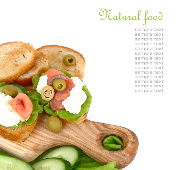 Salmon, lettuce and fresh cucumber sandwiches on a white background. — Stock Photo, Image