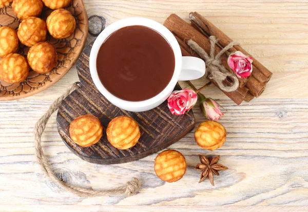 Copa de chocolate caliente en el corazón de madera y galletas sobre un fondo de madera . — Foto de Stock