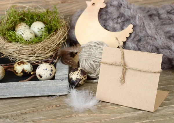 Easter background with eggs in a nest, wooden chicken and a place for the text. — Stock Photo, Image