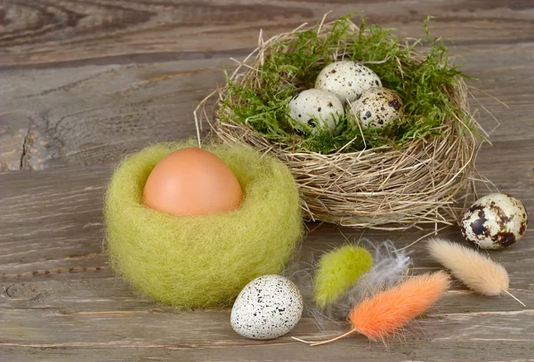 Ovos de Páscoa em ninhos em um fundo de madeira. Fundo pascal . — Fotografia de Stock