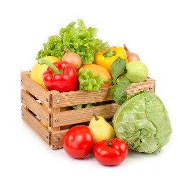 Fresh vegetables and fruit in a wooden box on a white background.