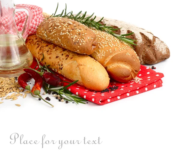 Fresh home-made bread and rosemary on a red napkin on a white background. — Stock Photo, Image