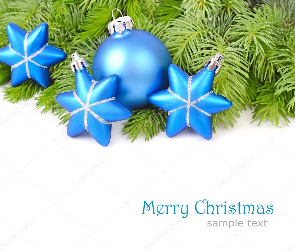 Blue Christmas balls and stars on branches of a Christmas tree on a white background. Christmas background.