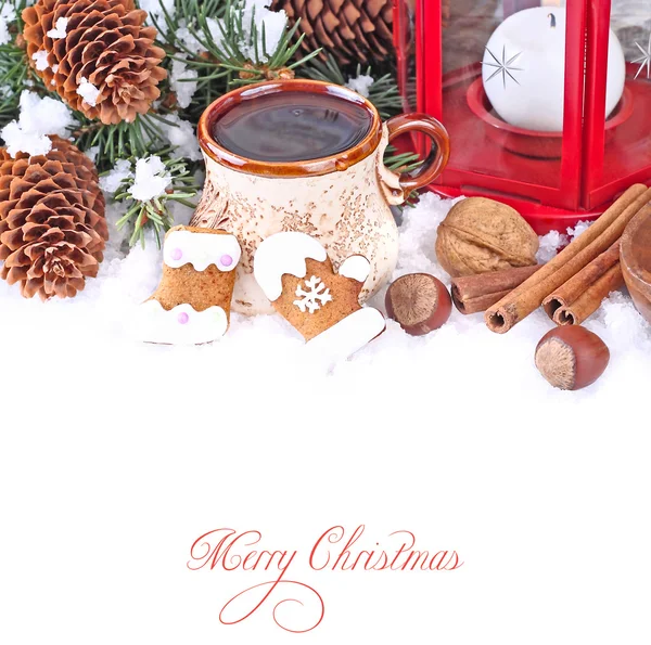 Cup of tea, ginger cookies and nuts near branches of a Christmas tree and cones on snow on a white background. A Christmas background with a place for the text. — Stock Photo, Image