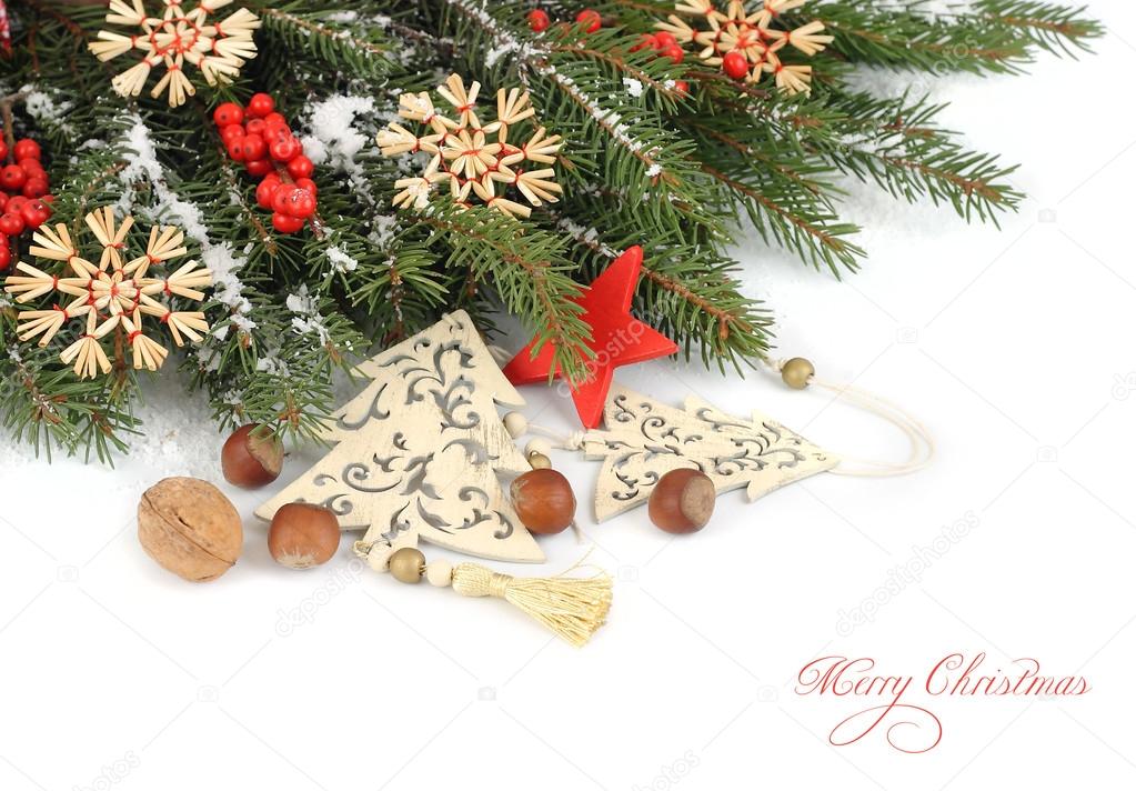 Decorative Christmas fir-trees on branches of a Christmas tree on a white background. A Christmas background with a place for the text.