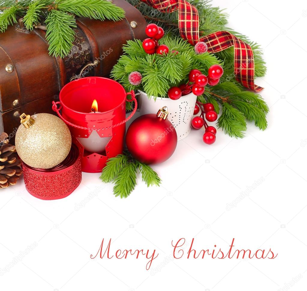 Christmas candlesticks, Christmas balls and branches of a Christmas tree near a wooden chest on a white background. A Christmas background with a place for the text.