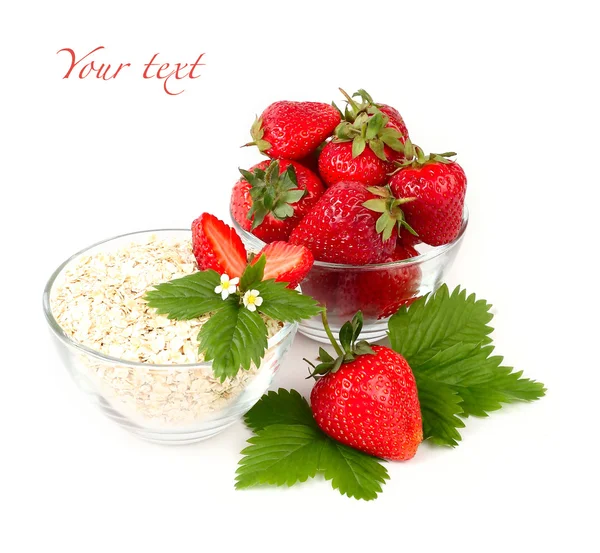 Ripe juicy strawberry and oat flakes in transparent ware on a white background. Natural organic simple food. — ストック写真