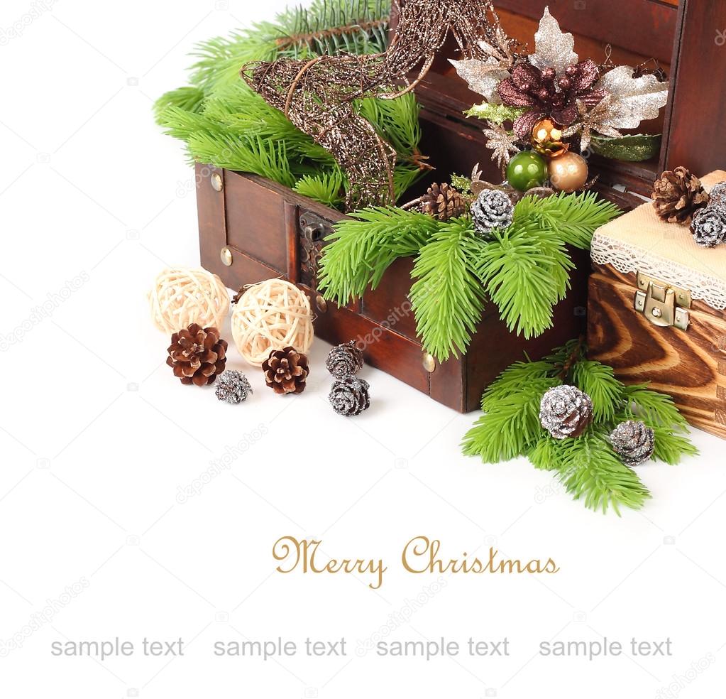 Decorative Christmas star and branches of a Christmas tree in a wooden chest on a white background. A Christmas background with a place for the text.