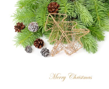 Golden metal openwork fir-tree and cones on branches of a Christmas tree on a white background. A Christmas background with a place for the text.