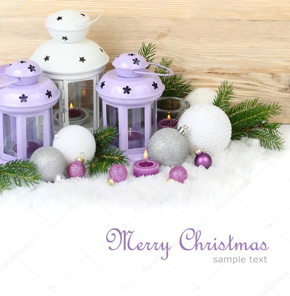 Violet and white lamps candlesticks and Christmas balls on snow on a white background. A Christmas background with a place for the text.