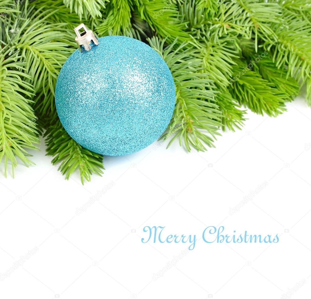 Blue Christmas ball on fluffy branches of a Christmas tree on a white background. A Christmas background with a place for the text.