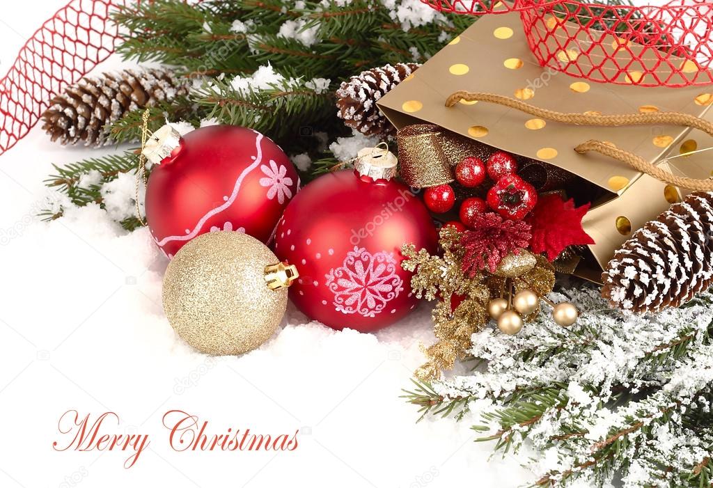 Christmas composition with branches of a Christmas tree, red and golden Christmas balls and cones on a white background. A Christmas background with a place for the text.