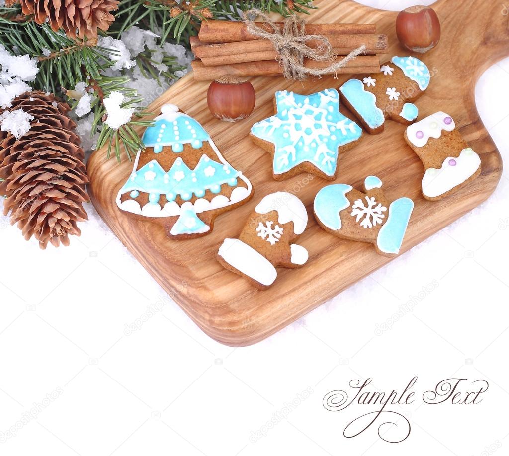 Christmas ginger cookies, nuts and cinnamon on a white background. A Christmas background with a place for the text.