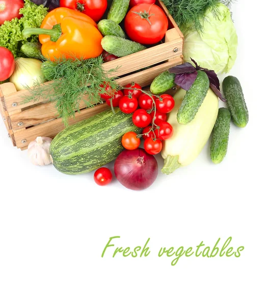 Fresh ripe vegetables in a wooden box on a white background with a place for the text. — Stock Photo, Image