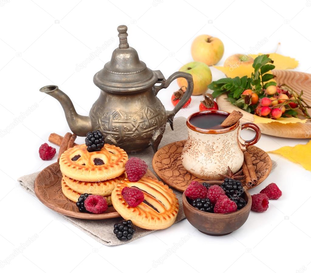 Autumn breakfast with coffee, berry cookies, raspberry and blackberry on a white background. An autumn background with a place for the text.