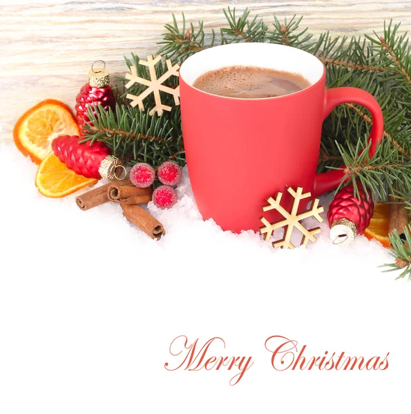 Red mug of hot chocolate on snow on a white background. A Christmas background with a place for the text.