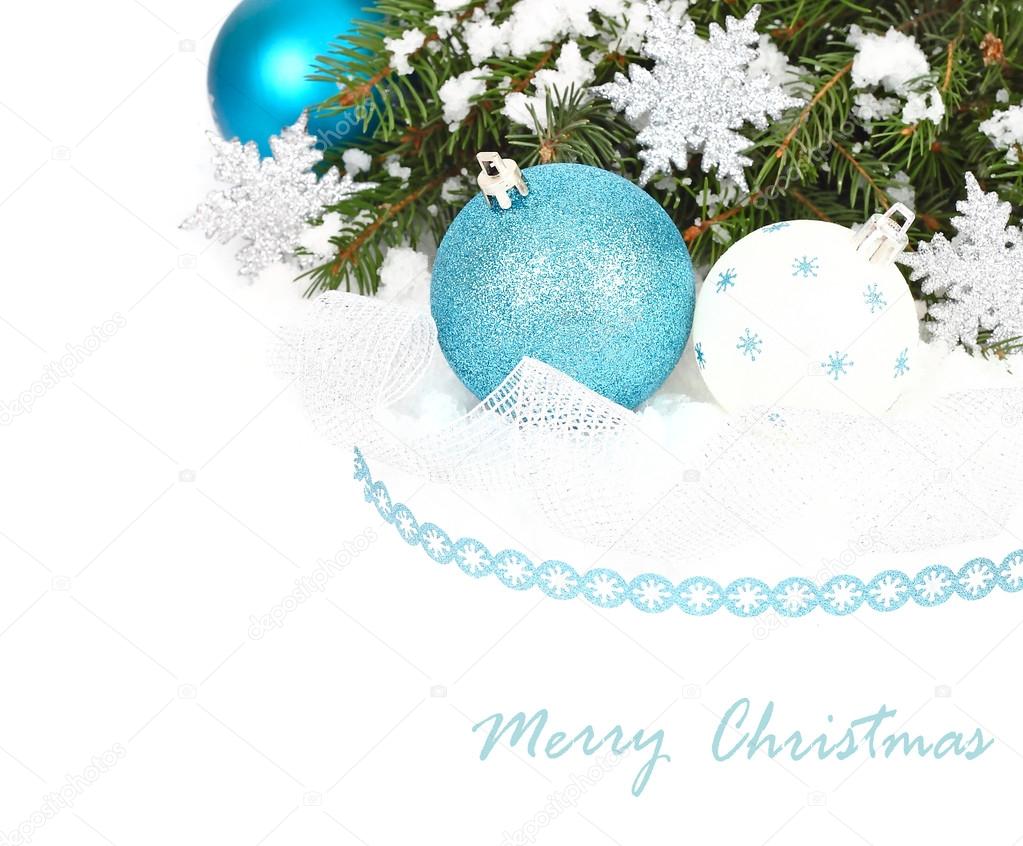 Blue and white Christmas balls and silvery snowflakes on a white background. A Christmas background with a place for the text.