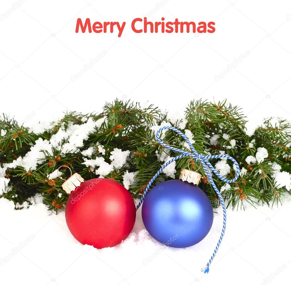 Blue and red Christmas balls and branches of a Christmas tree on a white background. A Christmas background with a place for the text.