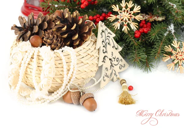 Christmas composition with cones in a wattled basket and other Christmas decor on a white background. A Christmas background with a place for the text. — Stockfoto