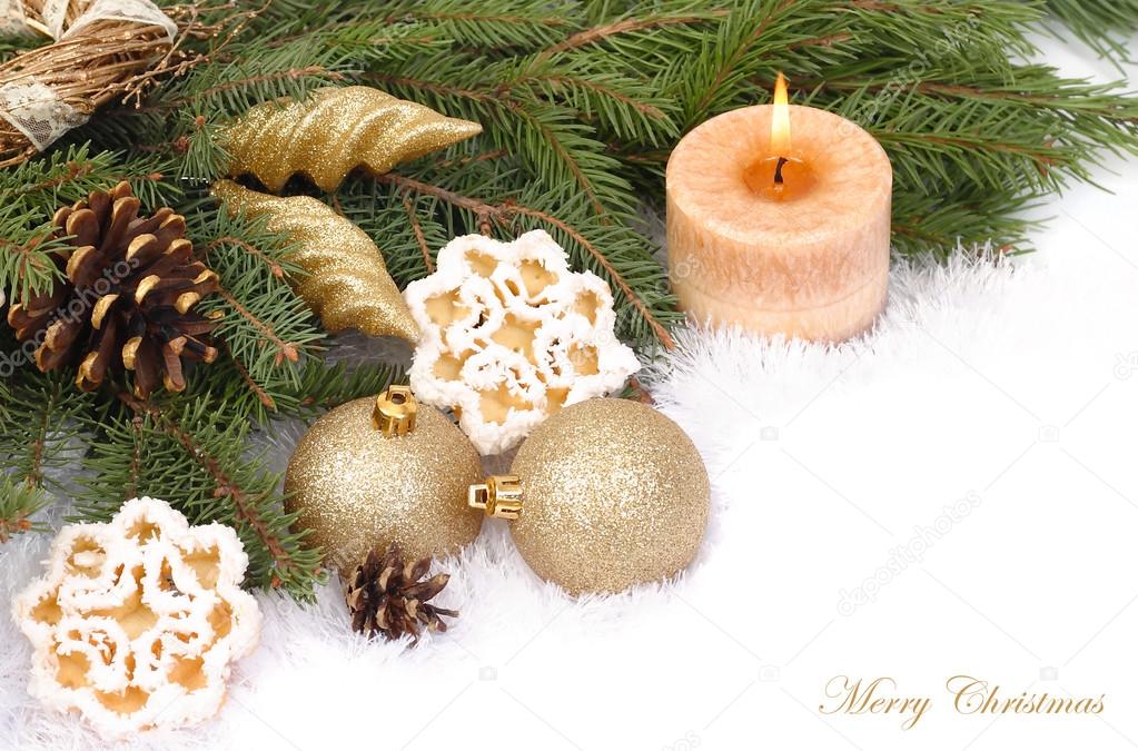 Christmas composition with golden Christmas balls and cones on snow-covered branches of a Christmas tree on a white background. A Christmas background with a place for the text.
