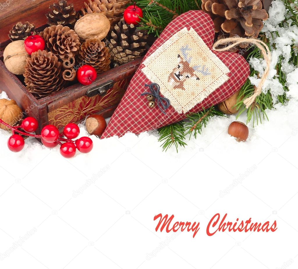 Textile checkered heart with a deer, cones and nuts on snow on a white background. A Christmas background with a place for the text.
