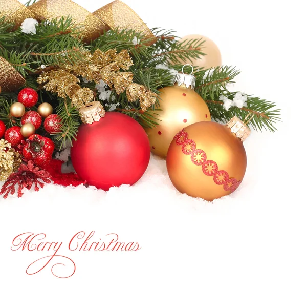 Red and golden Christmas balls on branches of a Christmas tree on snow on a white background. A Christmas background with a place for the text. — Stockfoto