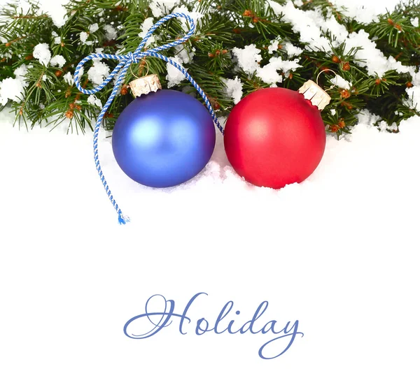 Red and blue Christmas balls and branches of a Christmas tree on snow on a white background. A Christmas background with a place for the text. — 스톡 사진