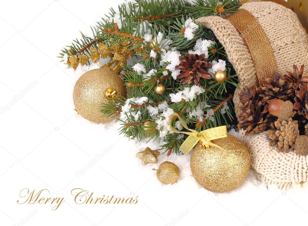 Golden Christmas balls, branches of a Christmas tree and the cones on snow on a white background. A Christmas background with a place for the text.