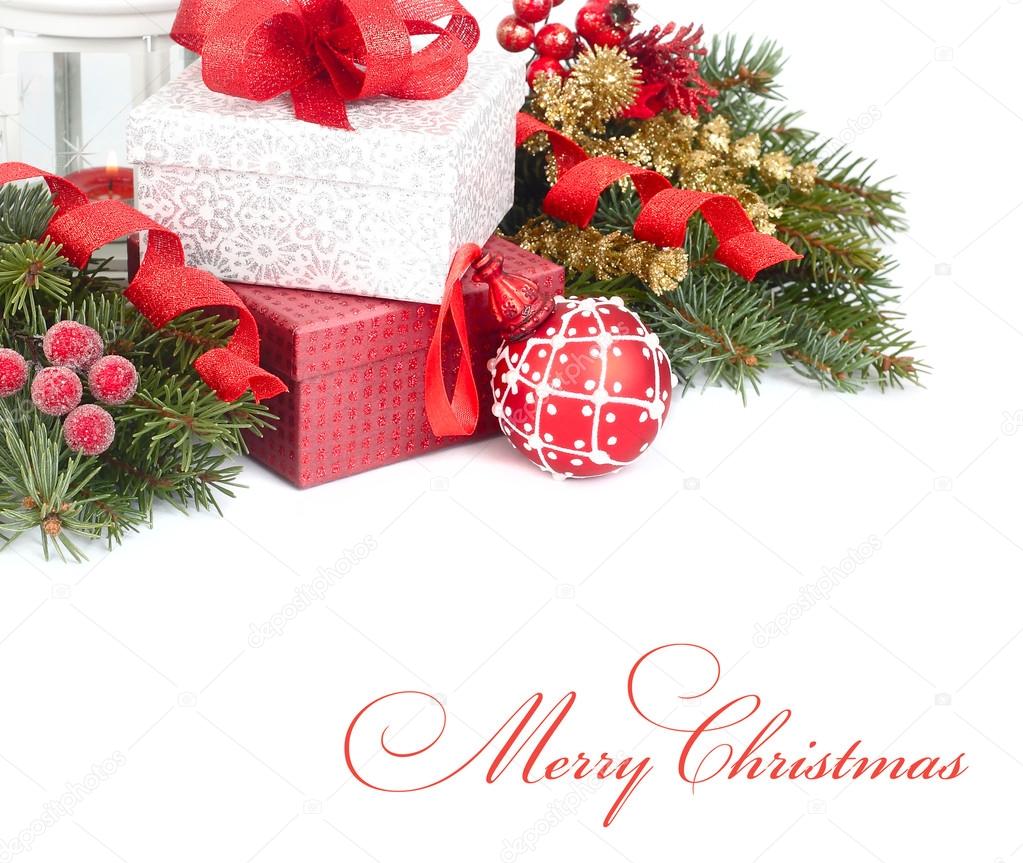 Christmas gift boxes with a red bow and red Christmas ball on branches of Christmas tree on a white background. A Christmas background with a place for the text.