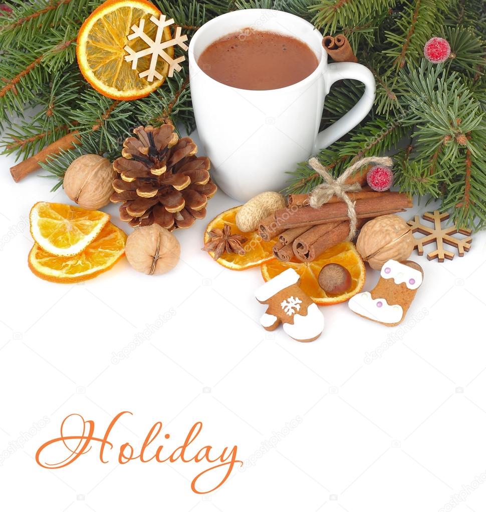 Mug of hot chocolate with ginger cookies, dried oranges, nuts and cinnamon on branches of a Christmas tree on a white background. A Christmas background with a place for the text.