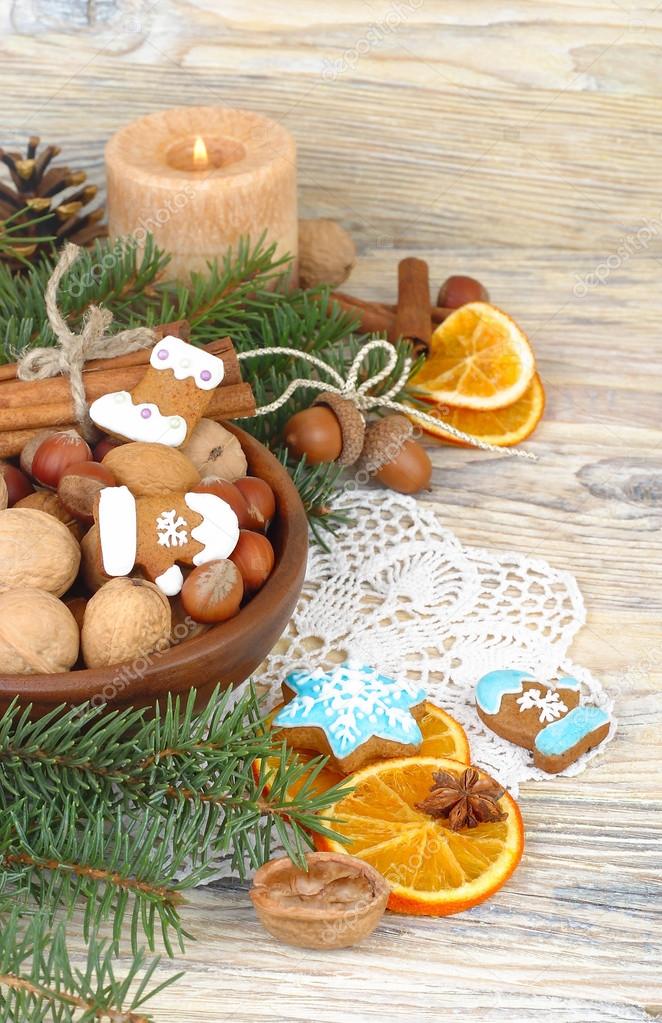 Christmas ginger cookies, nuts and dried oranges on a wooden background. A Christmas background with a place for the text.