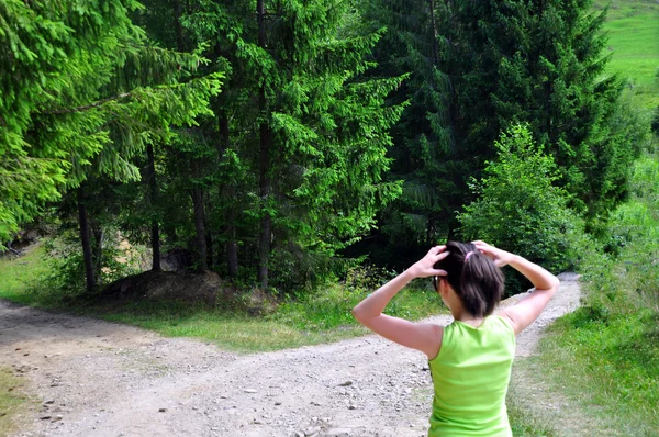 Menina com uma escolha perto da estrada bifurcada — Fotografia de Stock