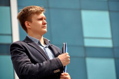 Arka plan cam üstündeki bir klasörle işadamı