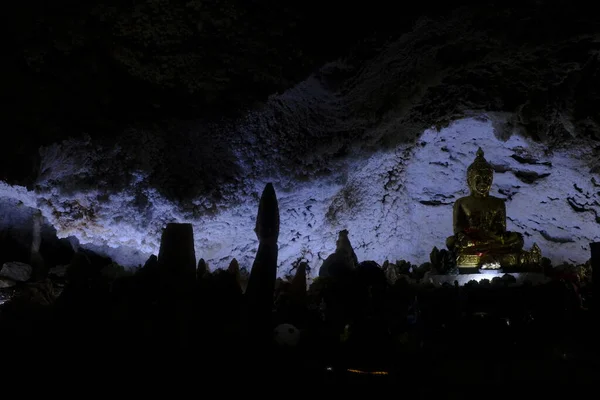 Image of Buddha in meditation pose with natural quartz crystals in crystal cave at Wat Tham Kanchanapisek in Khao Noi, Kanchanaburi province, Thailand.