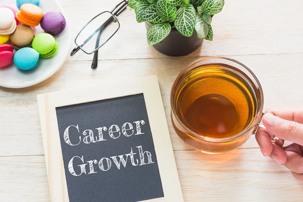 Concept Career Growth message on wood boards. Macaroons and glass Tea on table. Vintage tone. — Stock Photo, Image