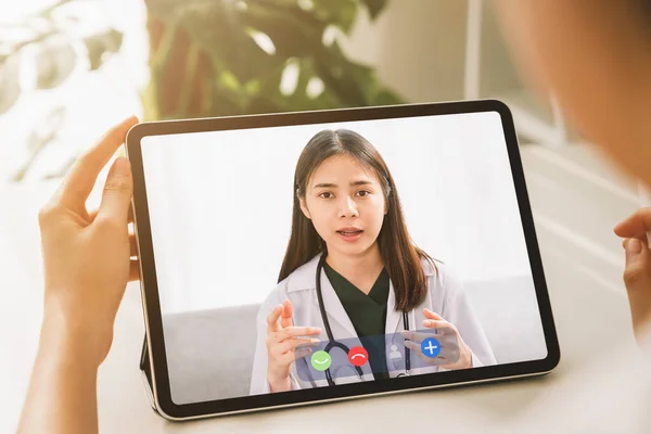 Woman making video call to doctor on tablet and provide help online counseling. Concept working from home.