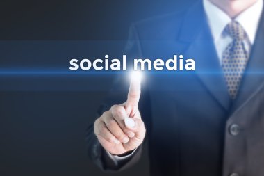 A Businessman holding a white sign with the message social media