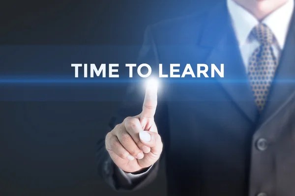 A Businessman holding a white sign with the message Time to Learn — 스톡 사진