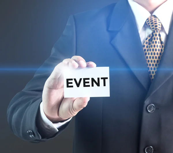 A Businessman holding a white sign with the message event — Stock Photo, Image