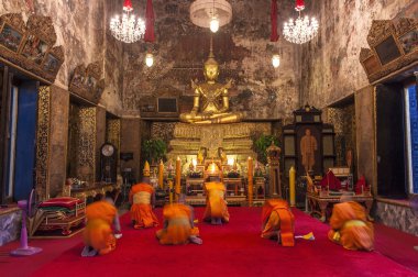 Monks praying in Buddhist Church clipart