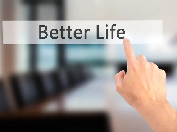 Mejor vida - Mano presionando un botón sobre el cono de fondo borroso — Foto de Stock