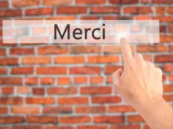 Merci - Hand pressing a button on blurred background concept on — Stock Photo, Image