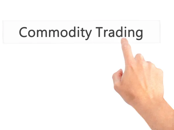 Commodity Trading - Hand pressing a button on blurred background — Stock Photo, Image