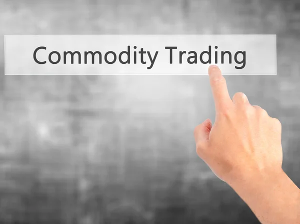 Commodity Trading - Hand pressing a button on blurred background — Stock Photo, Image