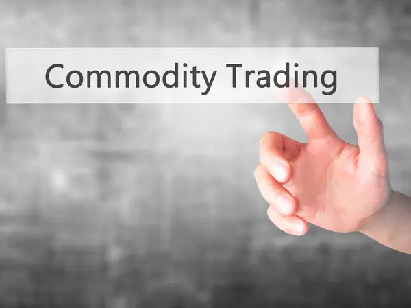 Commodity Trading - Hand pressing a button on blurred background — Stock Photo, Image