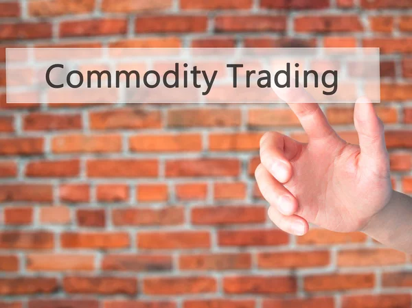 Commodity Trading - Hand pressing a button on blurred background — Stock Photo, Image