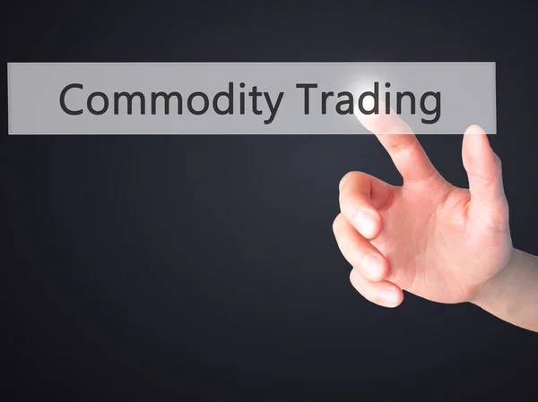 Commodity Trading - Hand pressing a button on blurred background — Stock Photo, Image