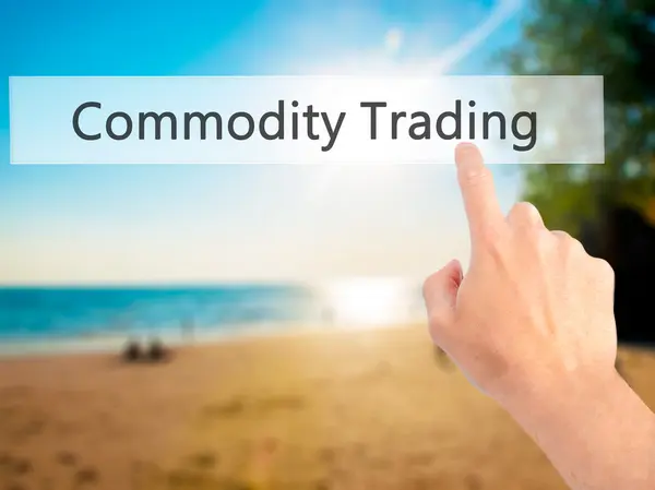 Commodity Trading - Hand pressing a button on blurred background — Stock Photo, Image